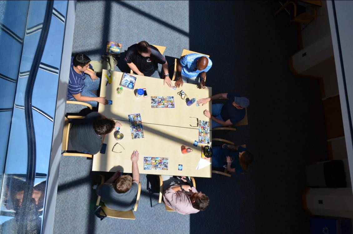 Staff play board games during lunch in atrium, 2017.
