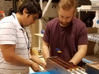 Pablo Campero and Tyler Lemon checking allignment of lead-glass blocks