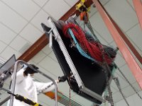 4 Collaborators lift E-panel over assembly frame