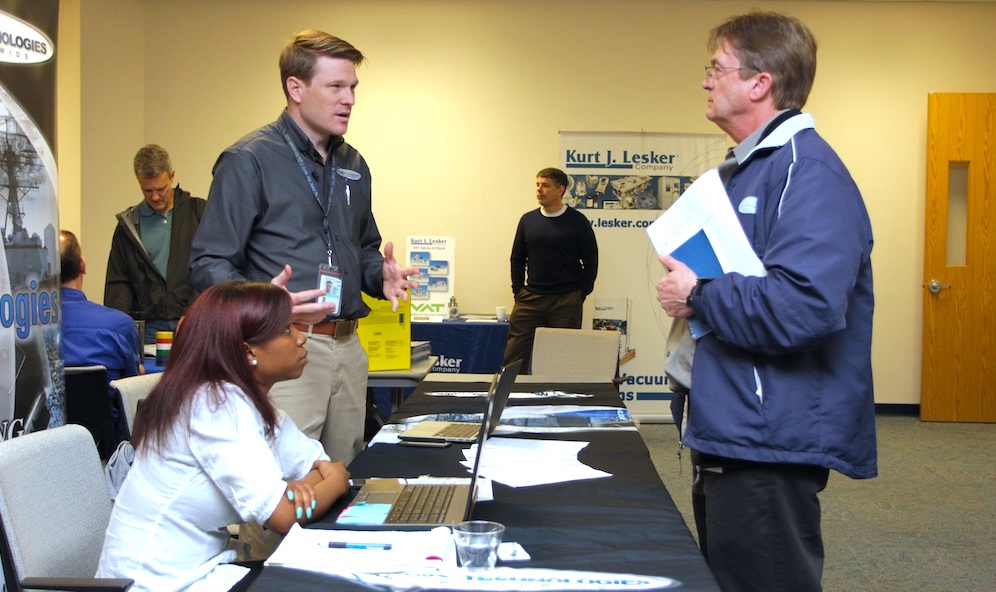 Photo of a lab staff member interacting with a vendor at the Vendor Fair 2015