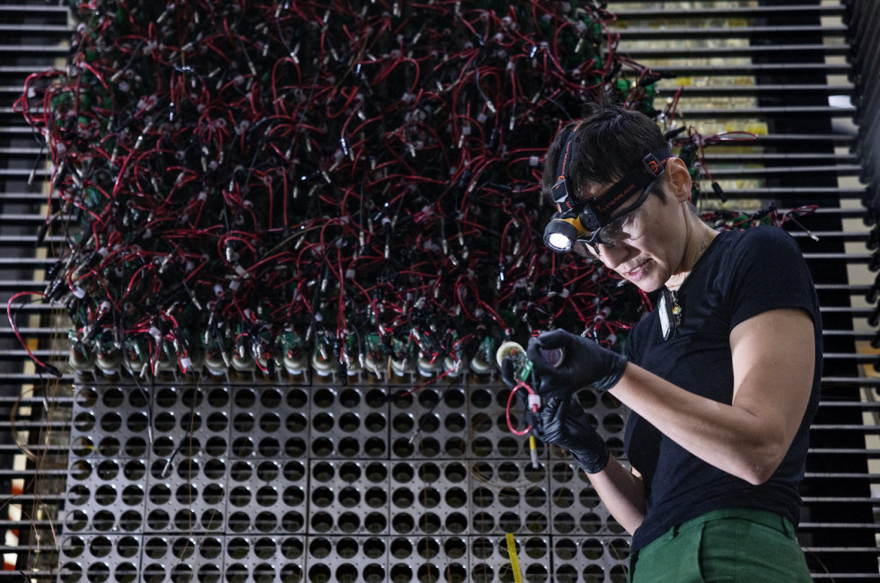 Hall A/C Staff Scientist Simona Malace works on the new electron calorimeter's photomultiplier tubes. (Jefferson Lab photo/Aileen Devlin)