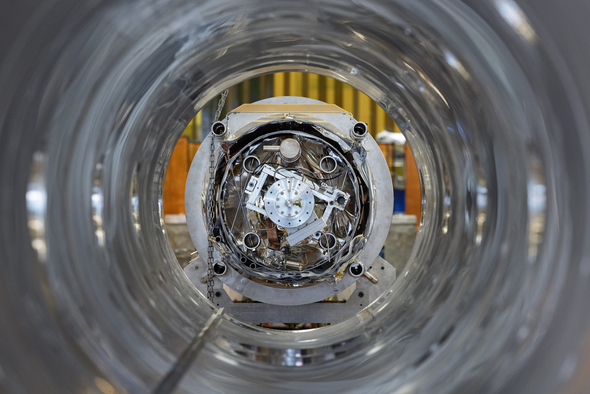 Looking down the empty barrel of a cryomodule are silver metallic interior components seen in the SRF Test Lab at Jefferson Lab in Newport News.