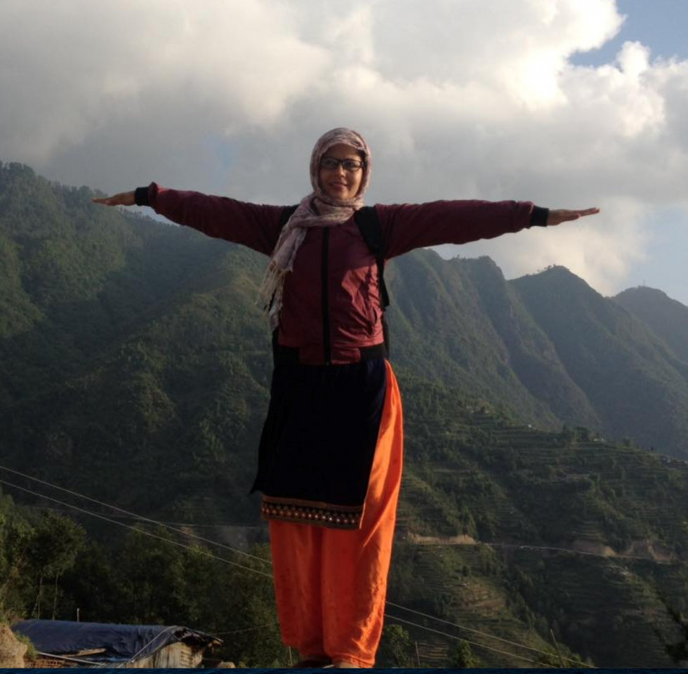 Woman stands on mountain 
