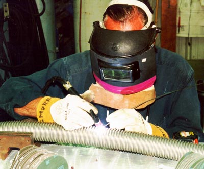 Brian Murphy mends a hole in stainless steel piping