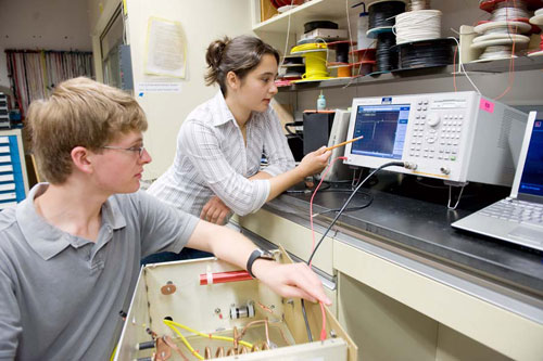 Peter Heuer and Heidi Baumgartner follow a reading on an oscilloscope.