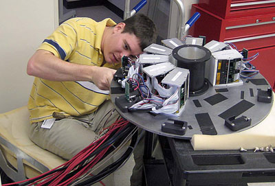 John McKisson, Radiation Detector and Imaging Group member, assembles components for a Single Photon Emission Computed Tomography Camera that the group designed, developed and built for Johns Hopkins University 