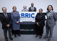 BRIC logo sign with (l-r) Drew Weisenberger, Cynthia Keppel, Allison Lung, Johnathon Huff, Asmeret Asefaw Berhe and Josh Shiode