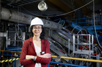 A woman stands in an experimental research hall.
