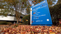 CEBAF Center directional sign with falling leaves