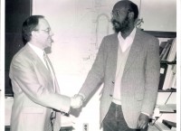  Jean Mougey (1935-2015, on left) and Warren Buck shake hand in 1985: HUGS is born!
