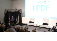 High Performance Data Facility Announcement Event in jefferson labs auditorium with podium and a display screen