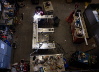The letter E in LOVE beig welded together from above 
