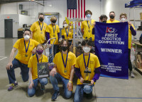 Triple Helix Team with robot and competition banner