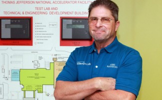 Tim Minga in front of a fire protection system panel