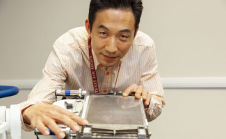 Seungjoon Lee is shown with the VASH collimator he developed.