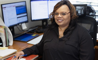 Stephanie Tysor at her desk with one of her journals