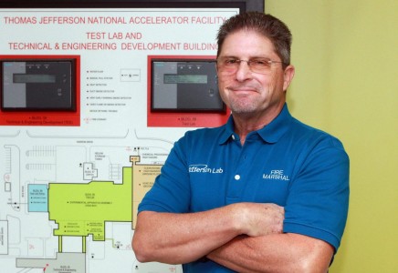 Tim Minga in front of a fire protection system panel