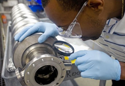 A seven-cell niobium cavity undergoes inspection