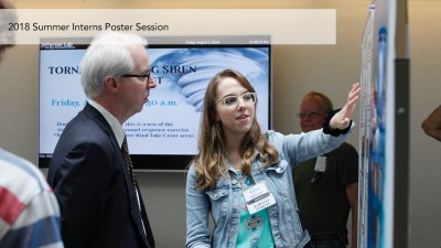 A student presents a poster during the 2018 Summer Intern Poster Session