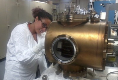 Program participant Anahi Segovia working on a vacuum chamber