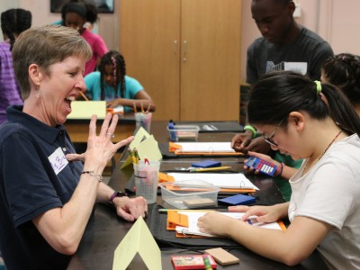 Deaf Science Camp Founder Brita Hampton works with a student at the 2019 Deaf Science Camp