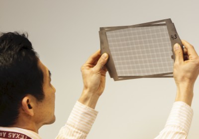 An inventor inspects components of a device that he invented