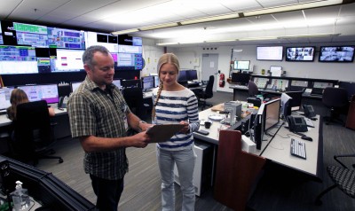 Anna Sabalina (left) confers with an accelerator operator in the CEBAF control room.