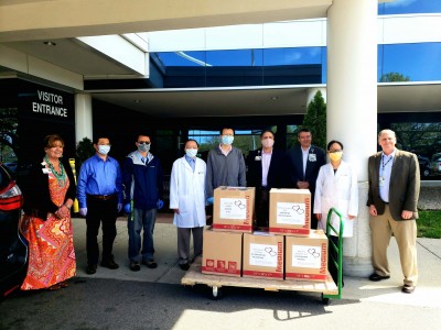 Members of the Peninsula Chinese American Association and the Tidewater Chinese School show boxes of supplies donated at local hospital