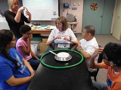 Jefferson Lab’s Brita Hampton explains to students how to conduct an activity called The Shape of Things