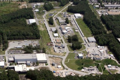 This aerial view of the Continuous Electron Beam Accelerator Facility shows the footprint of the accelerator and the experimental halls where nuclear physics experiments are conducted.The newest experimental facility, dubbed Hall D, which is part of the 12 GeV Upgrade, is visible in the upper left.