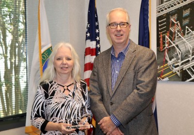 Elaine Claiborne accepts the 2018 Small Business of the Year award from Jefferson Lab Director Stuart Henderson