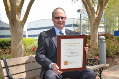 Photo of Kevin Jordan with framed 2016 NASA Invention of the Year award.