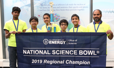 Team Photo of 1st place winners with National Science Bowl banner and trophy