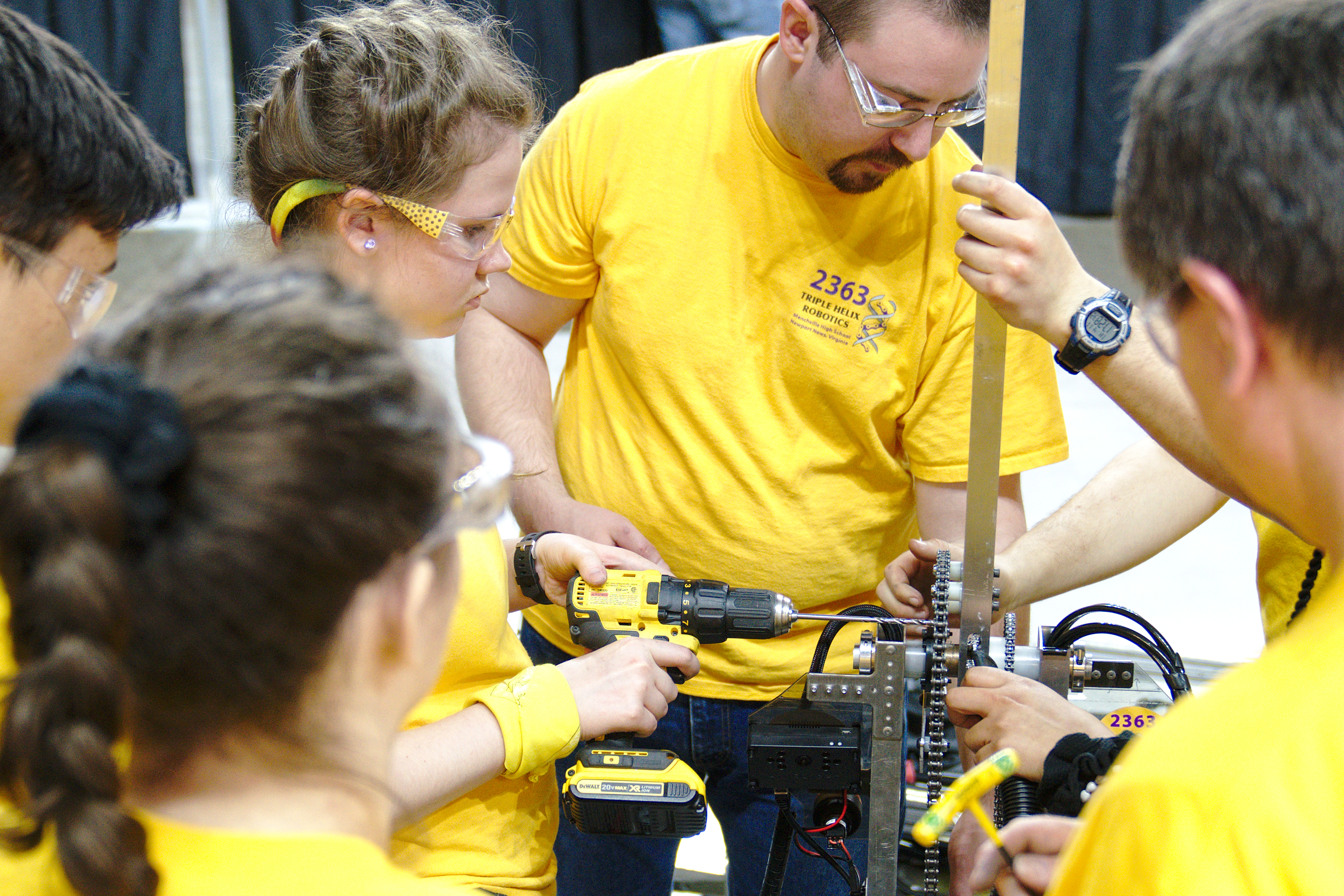 Nate Laverdure assists students with the robot